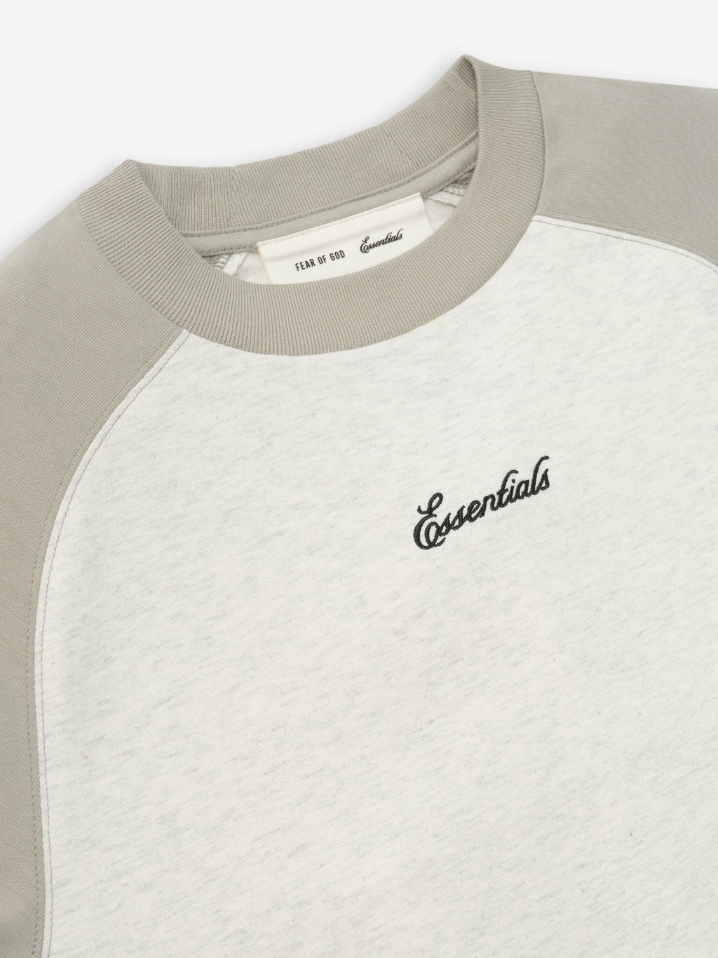 Baseball t-shirt with gray sleeves and white body on a light beige background