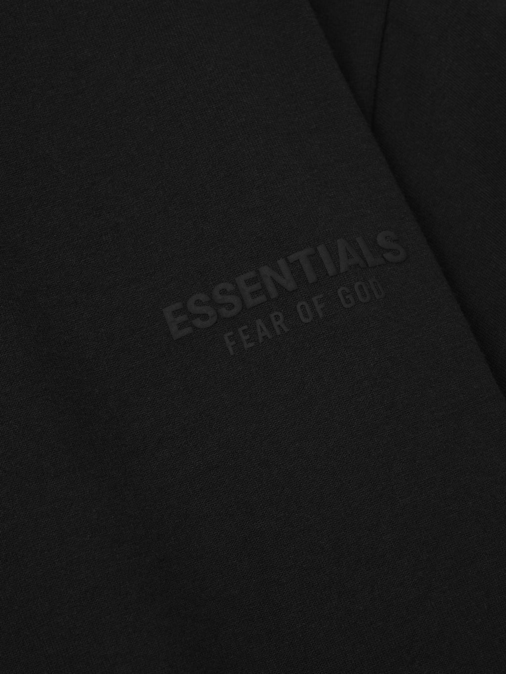 Black fabric with 'essentials Fear of God' puff print logo