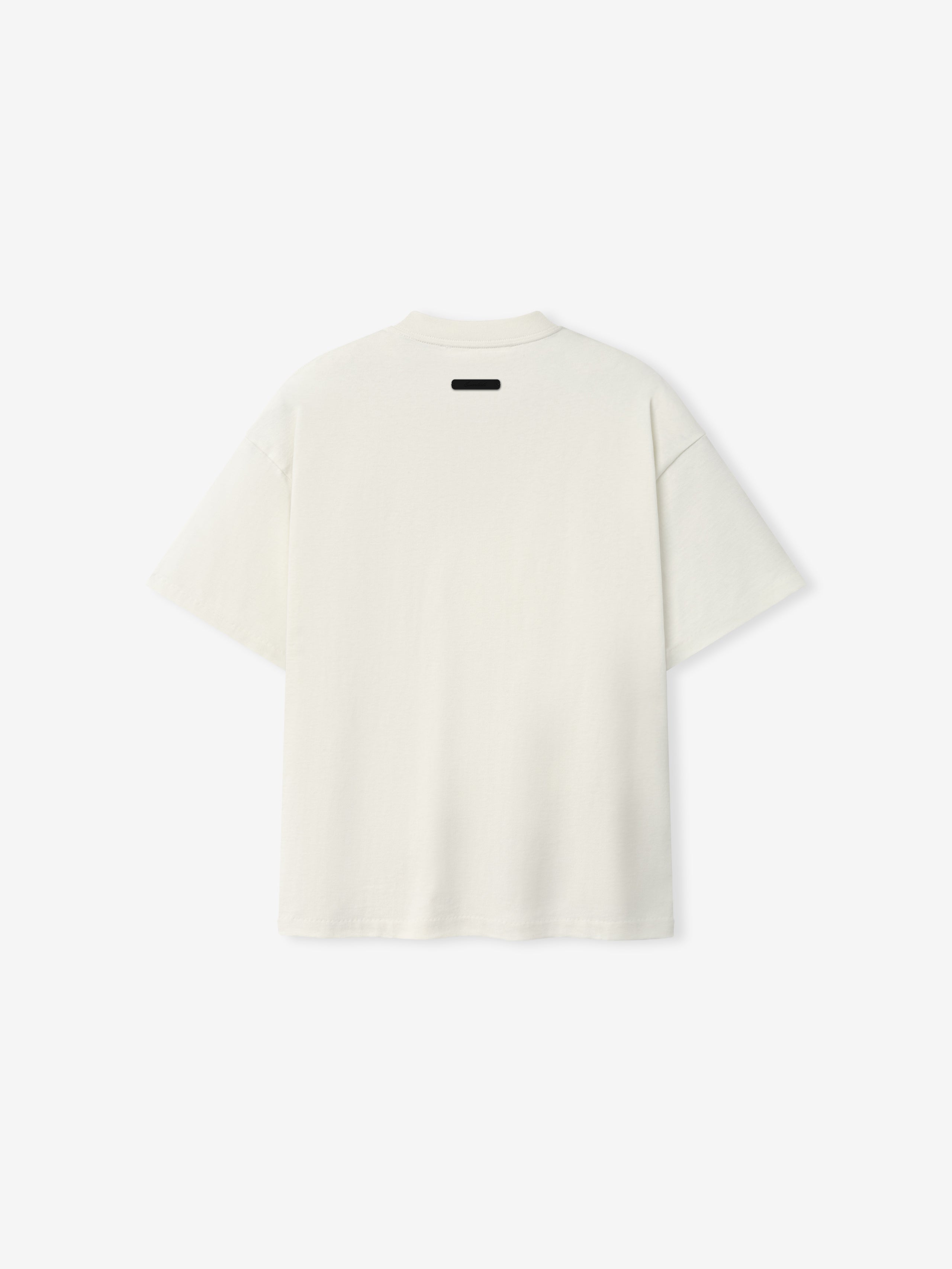 Back view of the Kids Signature 90s Tee in soft ivory fabric with a relaxed fit and a small black label detail at the neckline, designed for casual kids' wear.