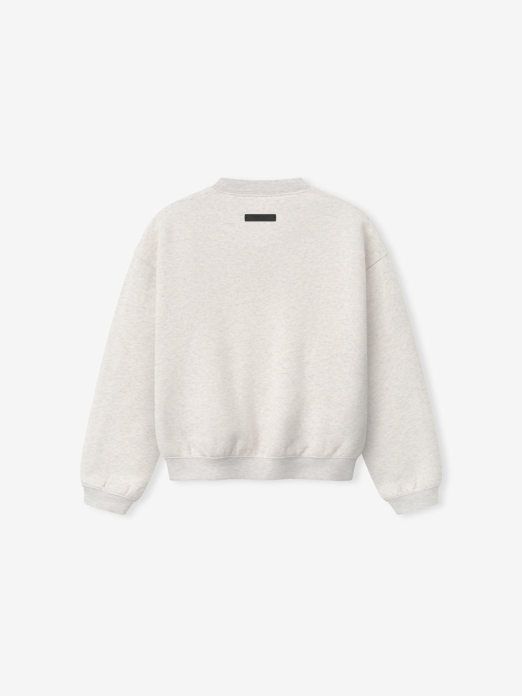 Back view of light beige crewneck sweatshirt with small black rectangular label at upper center and ribbed cuffs and hem