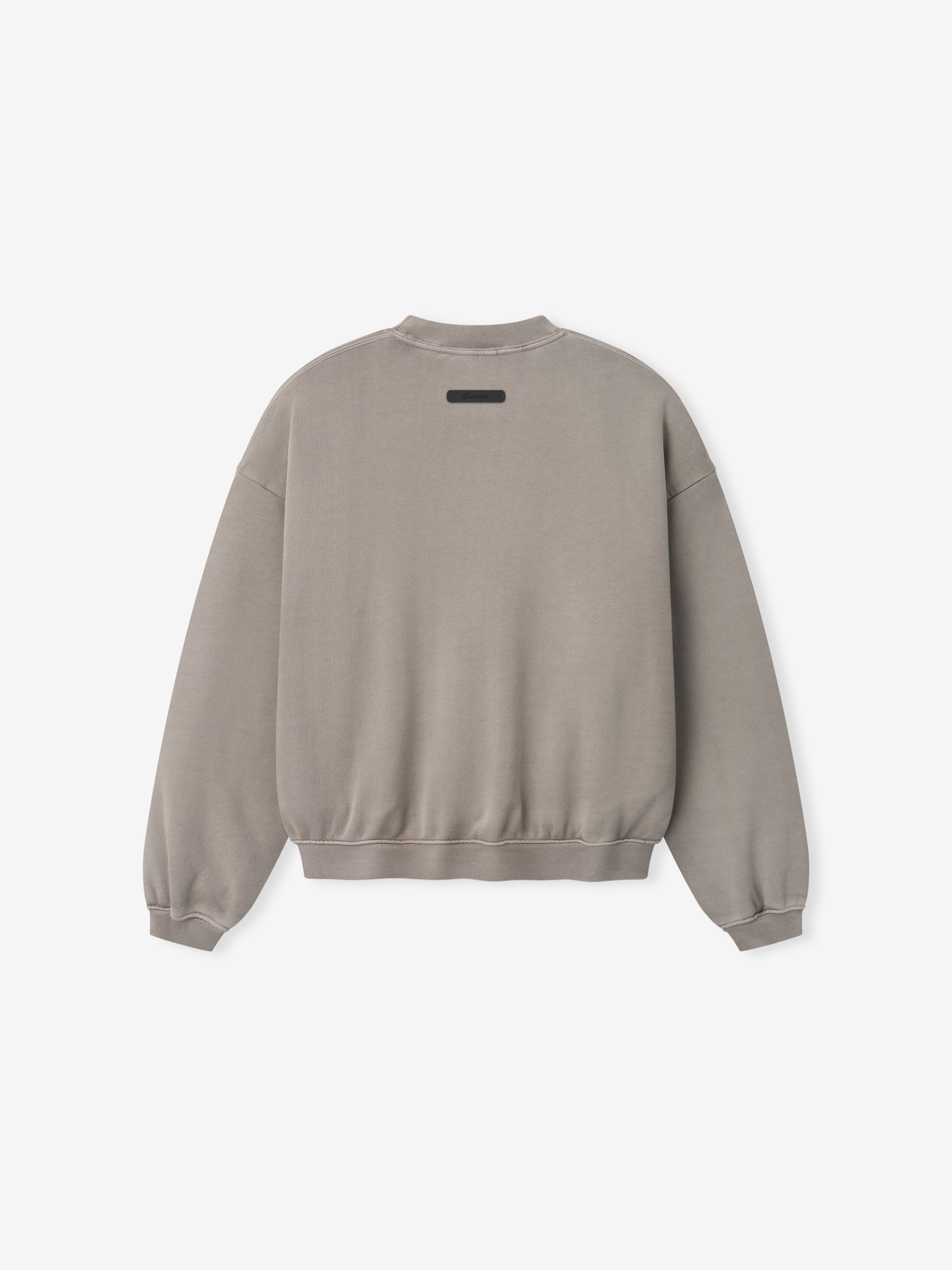 Light grey crewneck sweatshirt shown from back with ribbed cuffs and waistband and small rectangular patch near neckline
