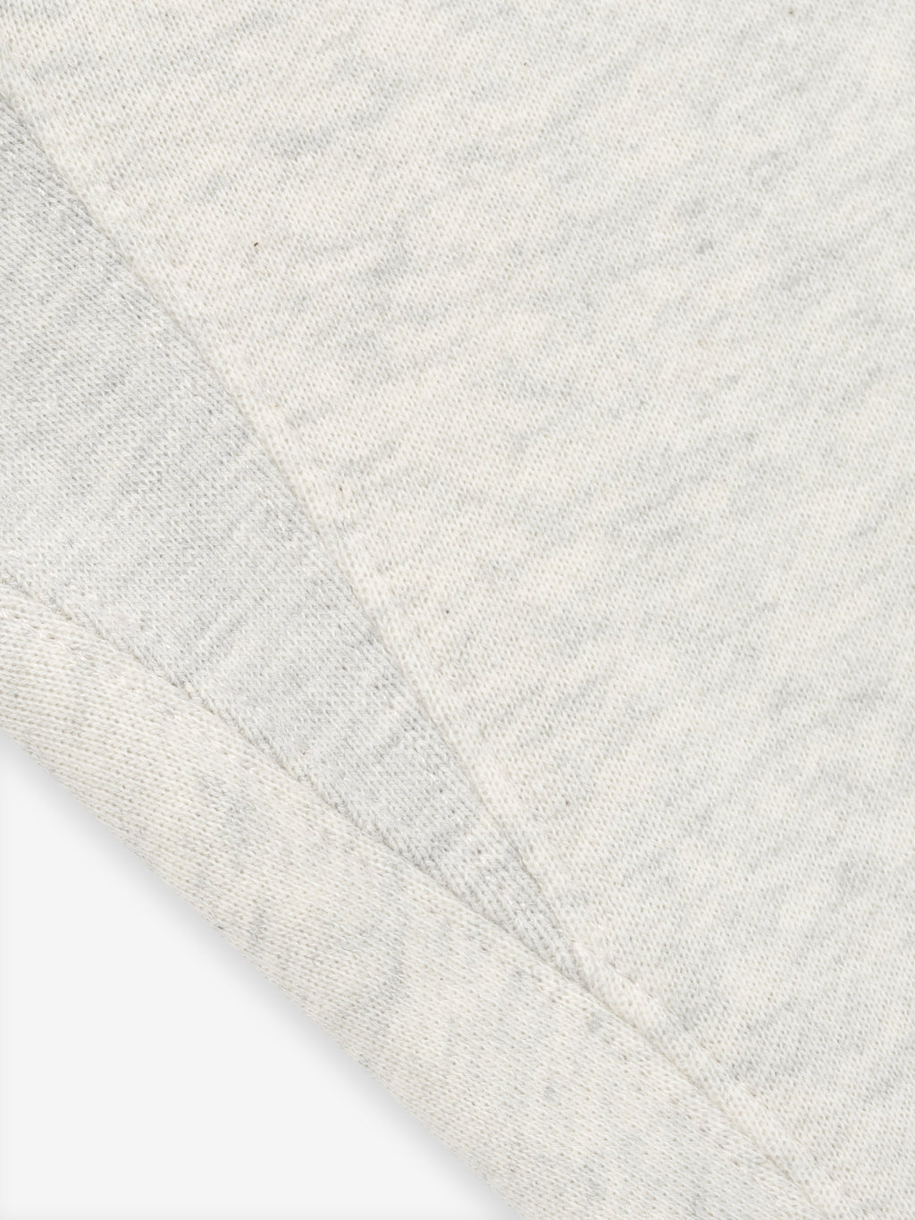 close-up of light grey Kids Classic Sweatpant fabric showing textured core fleece material and stitching details