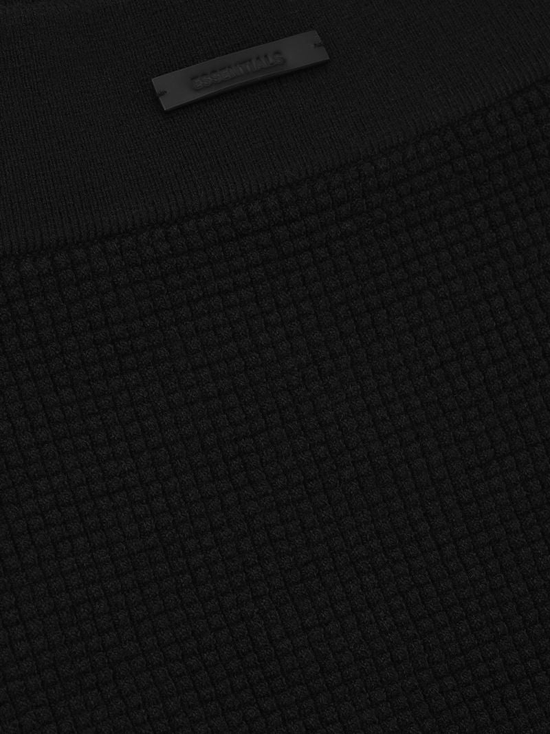 close-up of black women's waffle knit boy short fabric with textured grid pattern and elastic waistband detail