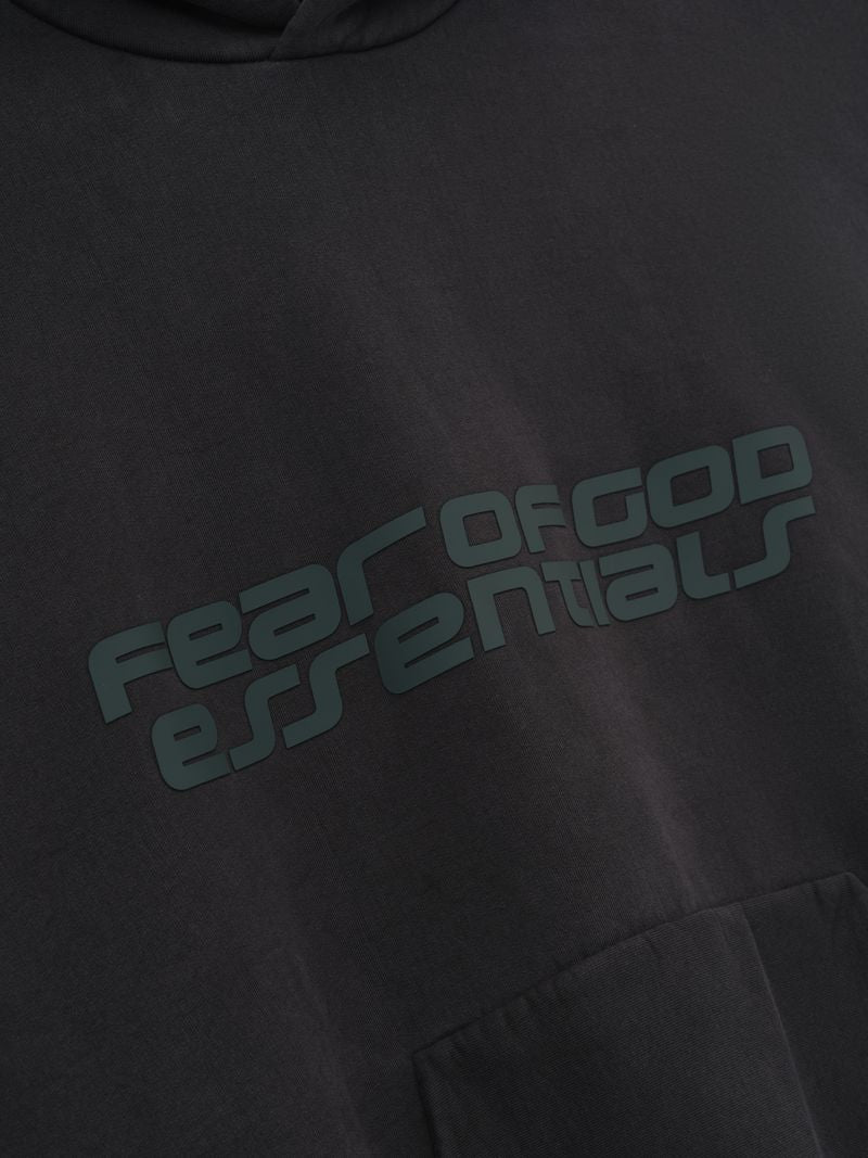 Close-up of black Heavy Fleece 90s Hoodie showing dark, diagonal Fear of God Essentials text print on front gallery CR9HA6yQ