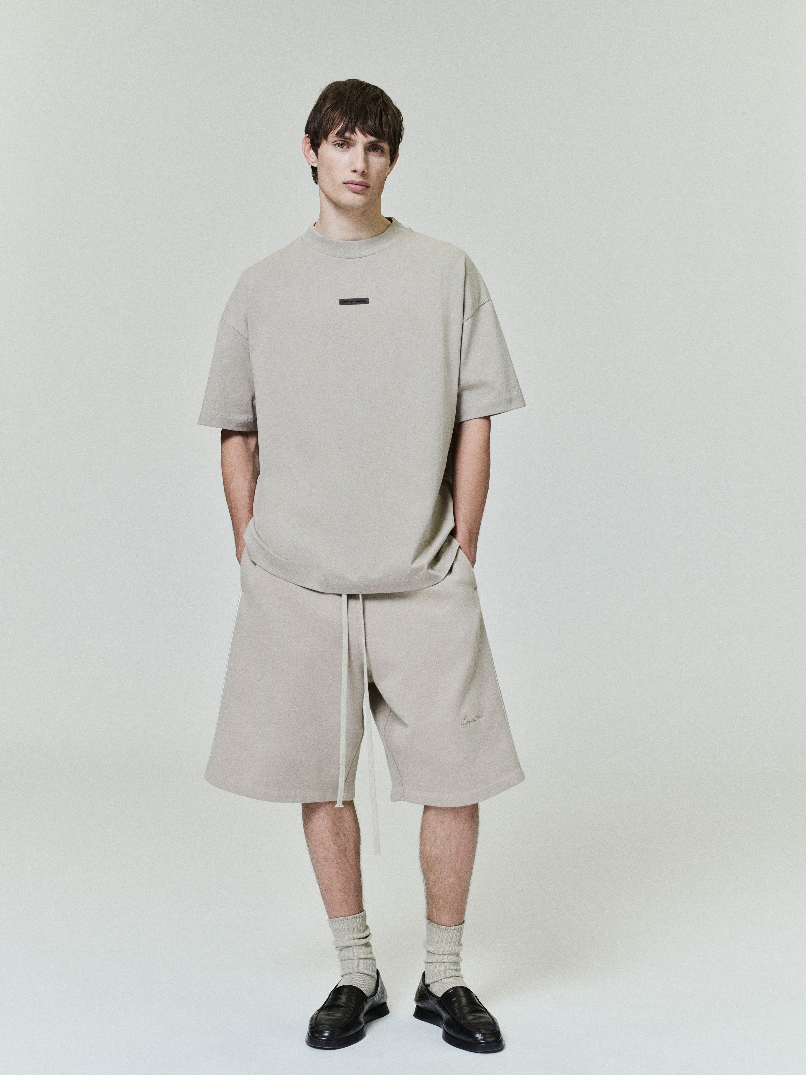 front view of light beige classic fit cotton jersey tee with rib-knit crewneck and small rectangular chest logo