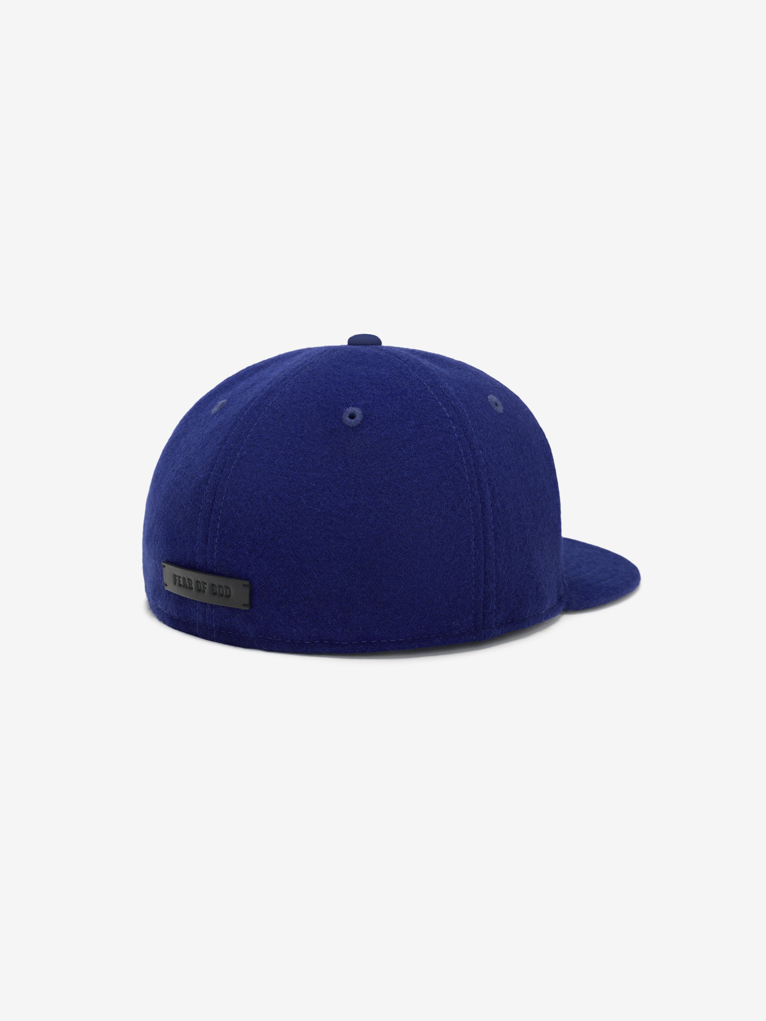 Rear three-quarter view of Los Angeles Dodgers Wool Retro Crown 59FIFTY fitted cap featuring Fear of God tag on deep blue wool crown