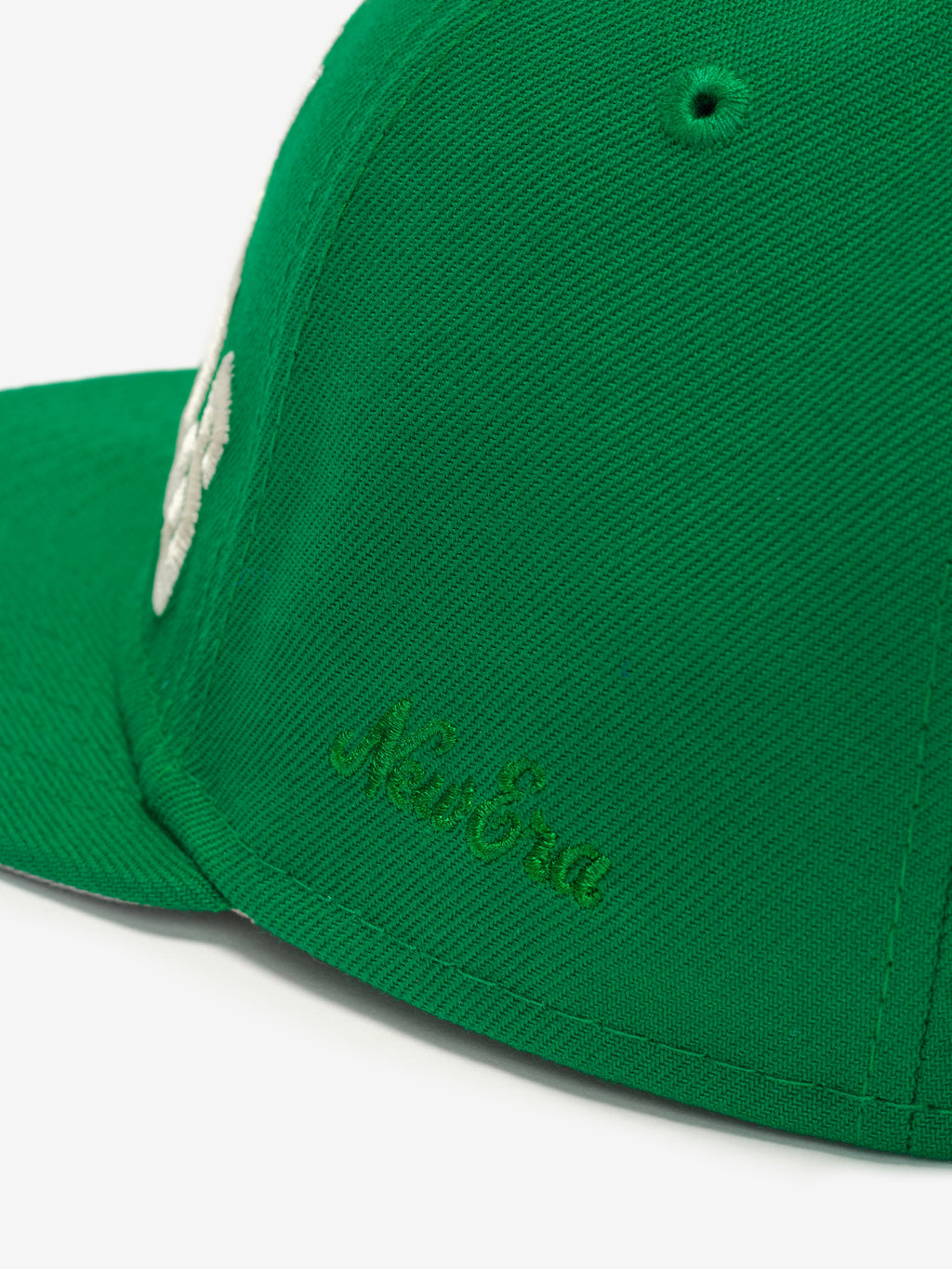 Close-up side view of green Eagles 9Fifty RC Snapback showing tonal New Era script embroidery, gallery image 0