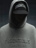Front view of Raiders 9Fifty RC Snapback with bold "Essential" embroidery, worn under grey Essentials hoodie, gallery image 0