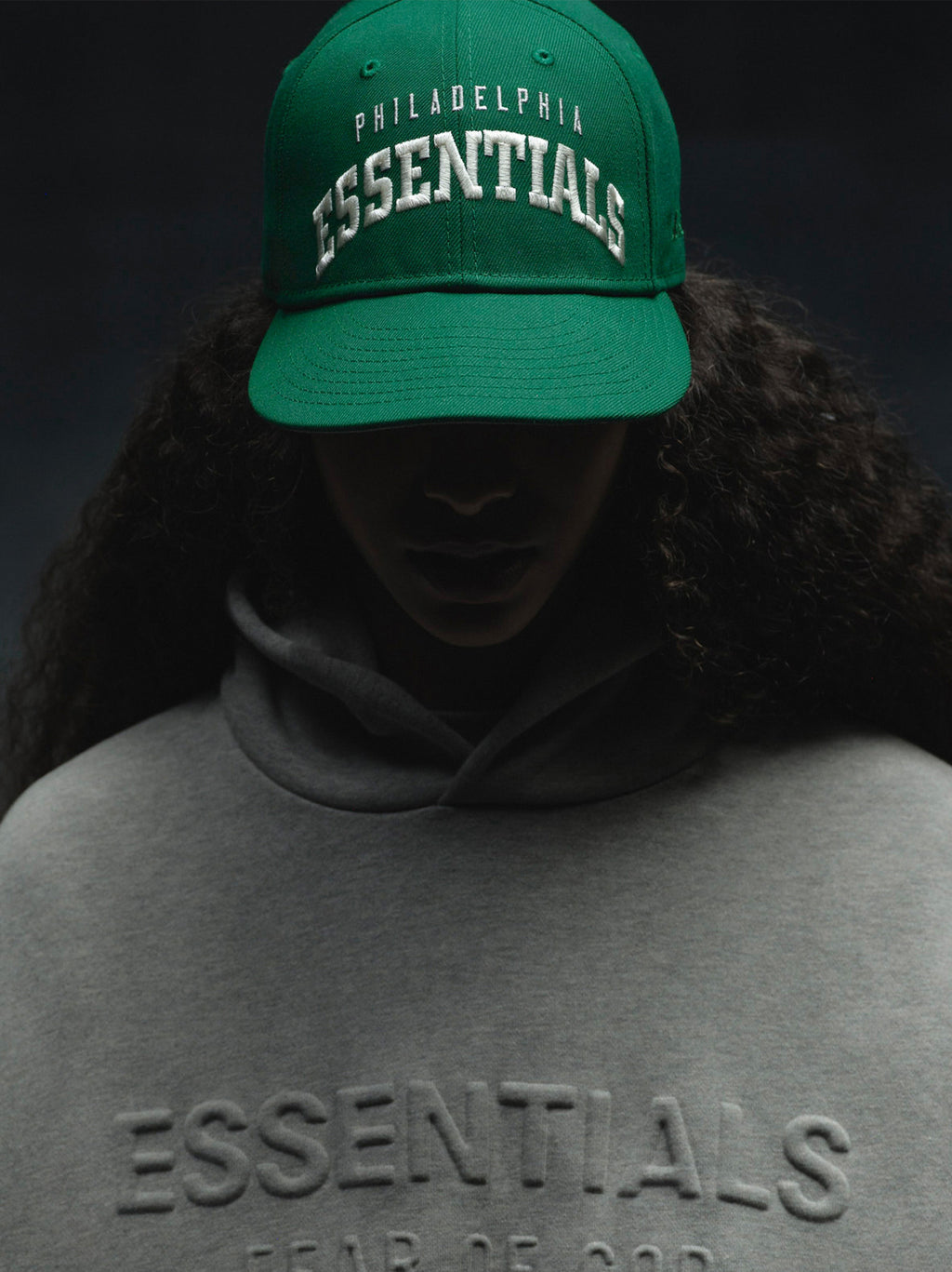 Front view of green Eagles 9Fifty RC Snapback with white Philadelphia Essentials embroidery, worn by shadowed model, IMAGE34v2.jpg