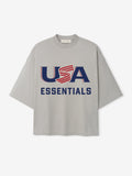 Light gray oversized short-sleeve T-shirt with navy and red "USA ESSENTIALS" graphic on front center