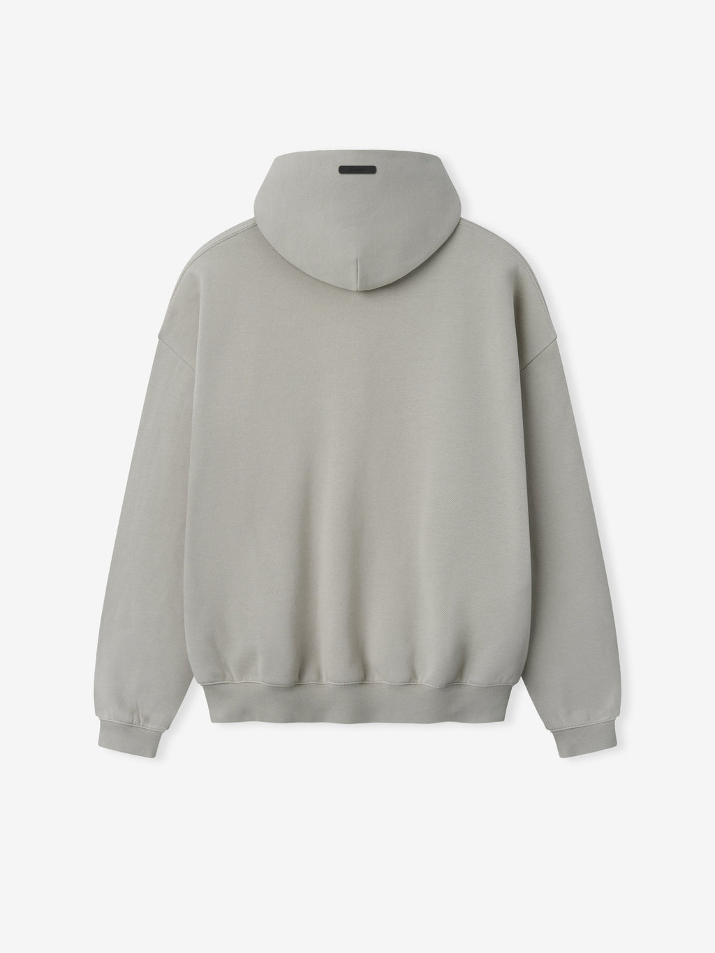 Back view of plain light gray hoodie with ribbed cuffs and waistband and a small black rectangular patch on hood