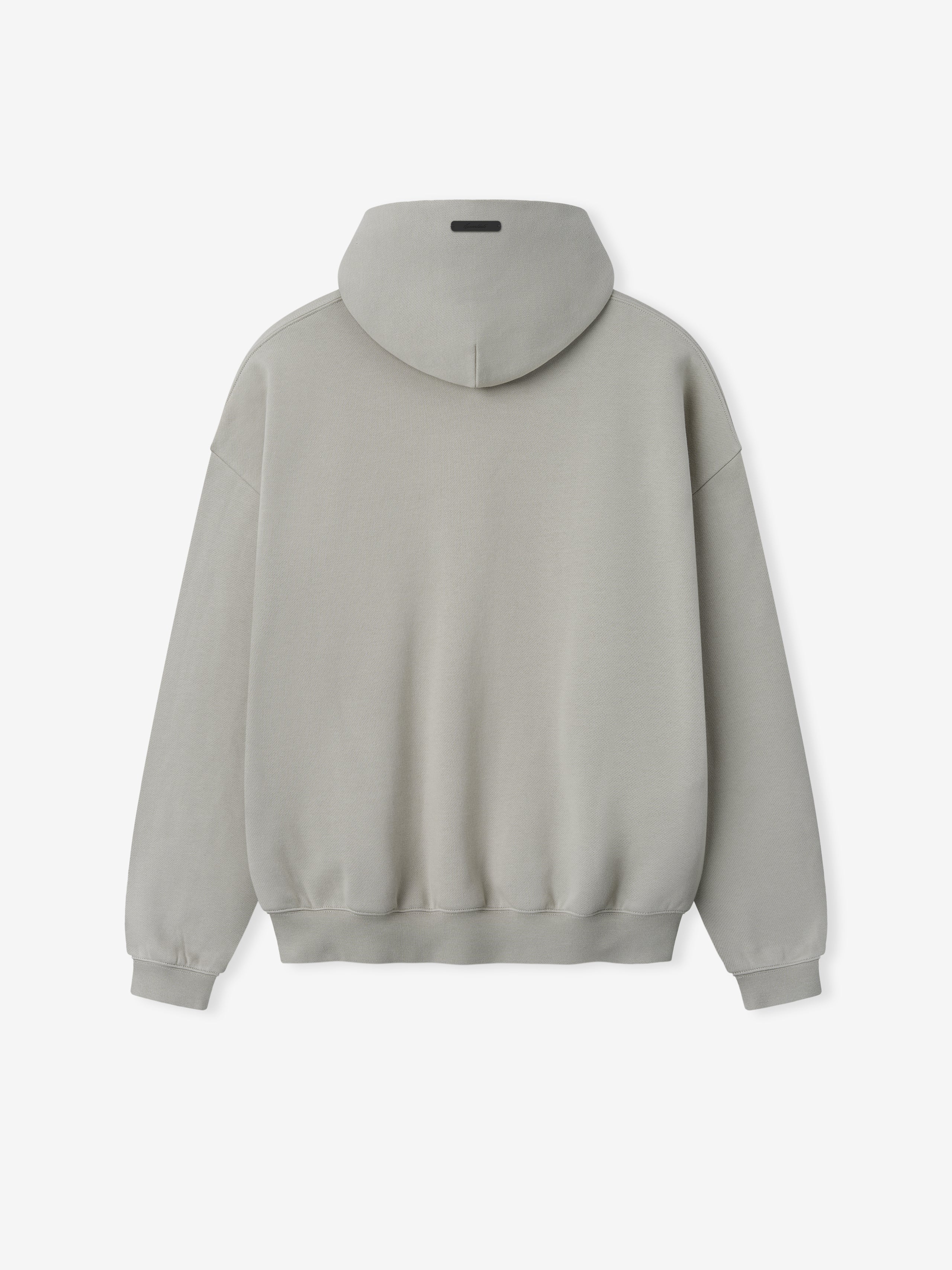 Back view of plain light gray hoodie with ribbed cuffs and waistband and a small black rectangular patch on hood