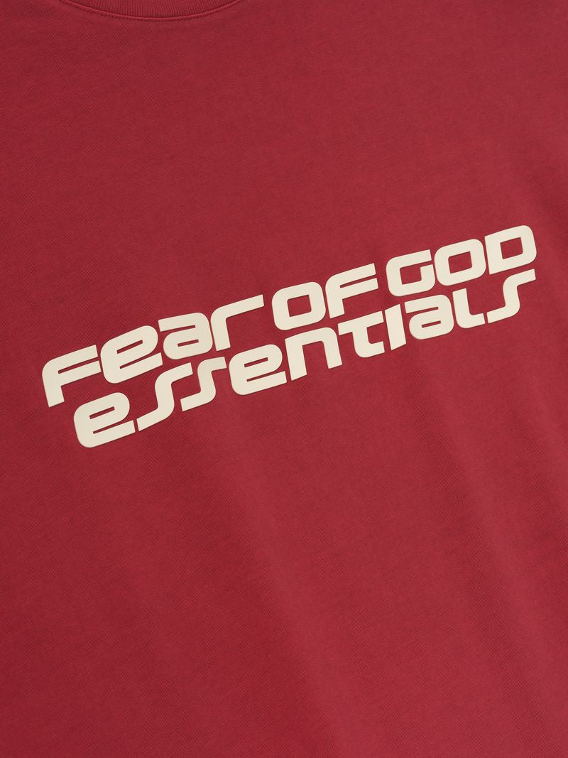 Close-up of crimson 90s Long Sleeve Tee with bold Fear of God Essentials logo printed diagonally across chest, gallery 0 Rd8VOMCg.jpg