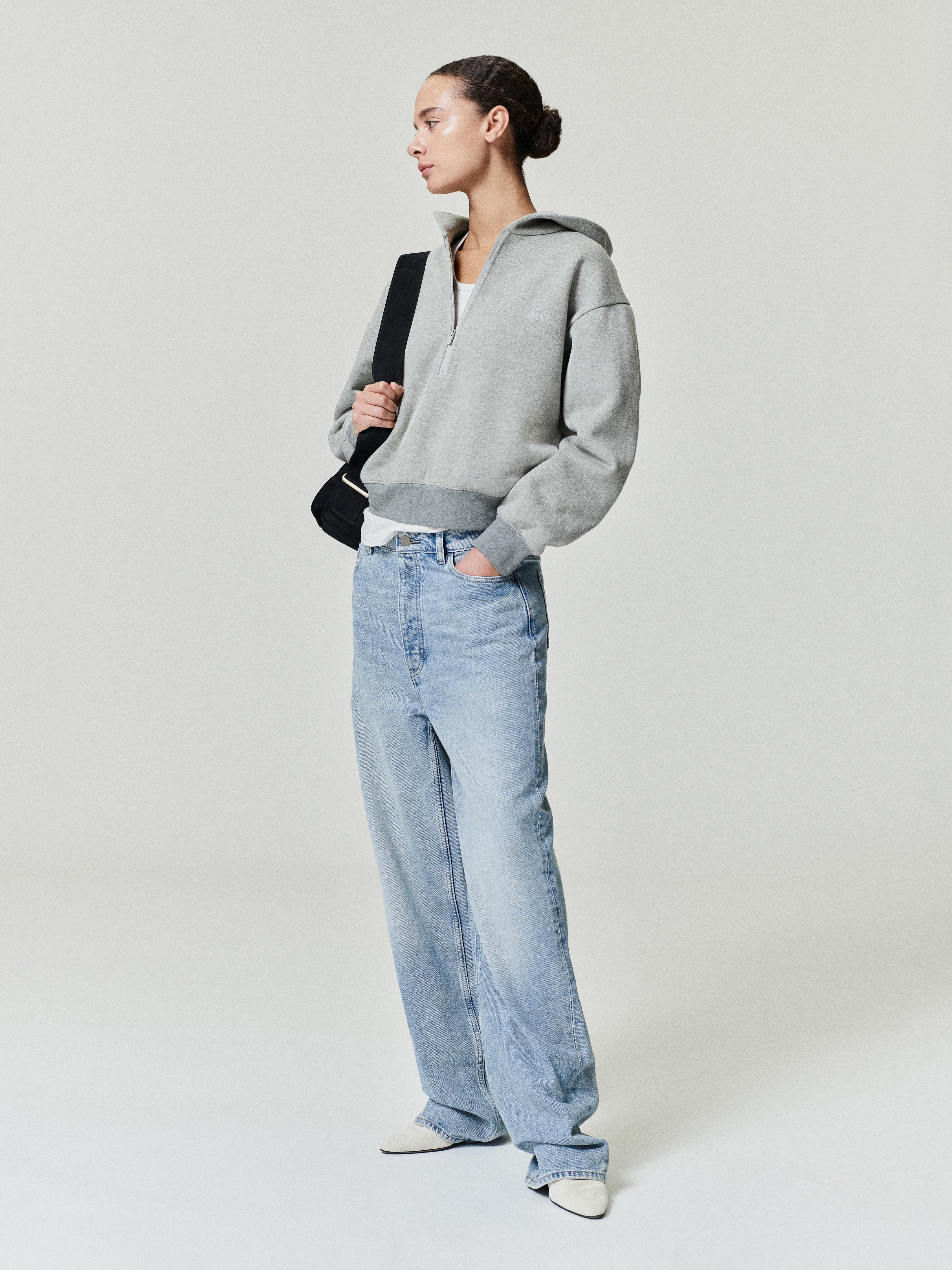 woman wearing vintage wash light blue straight leg denim jeans with relaxed boyfriend-inspired fit and low rise