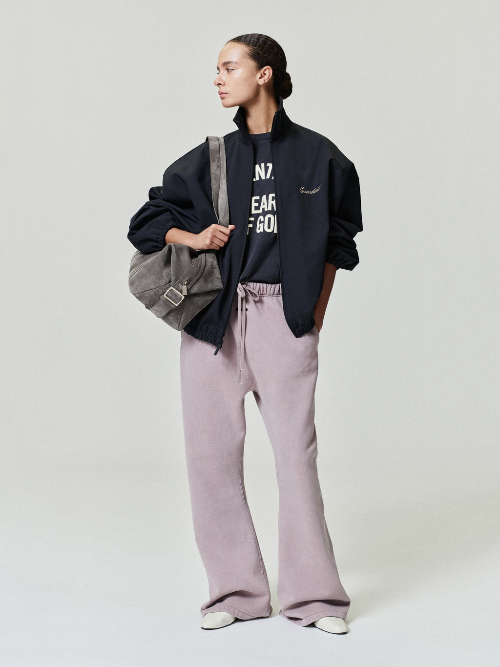 woman wearing relaxed fit flare sweatpants in washed vintage mauve with elastic drawstring waistband