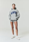 Front view of model wearing grey Memphis Grizzlies 90'S Hoodie with navy text, image SP26_FW_L44-P_1691copy, gallery 0.