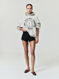 off-white oversized hoodie with circular NBA Essentials text and split basketball graphic on front worn by model