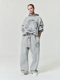 model wearing light gray heavyweight cotton fleece flare sweatpants with NBA Essentials circular logo and drawstring waist