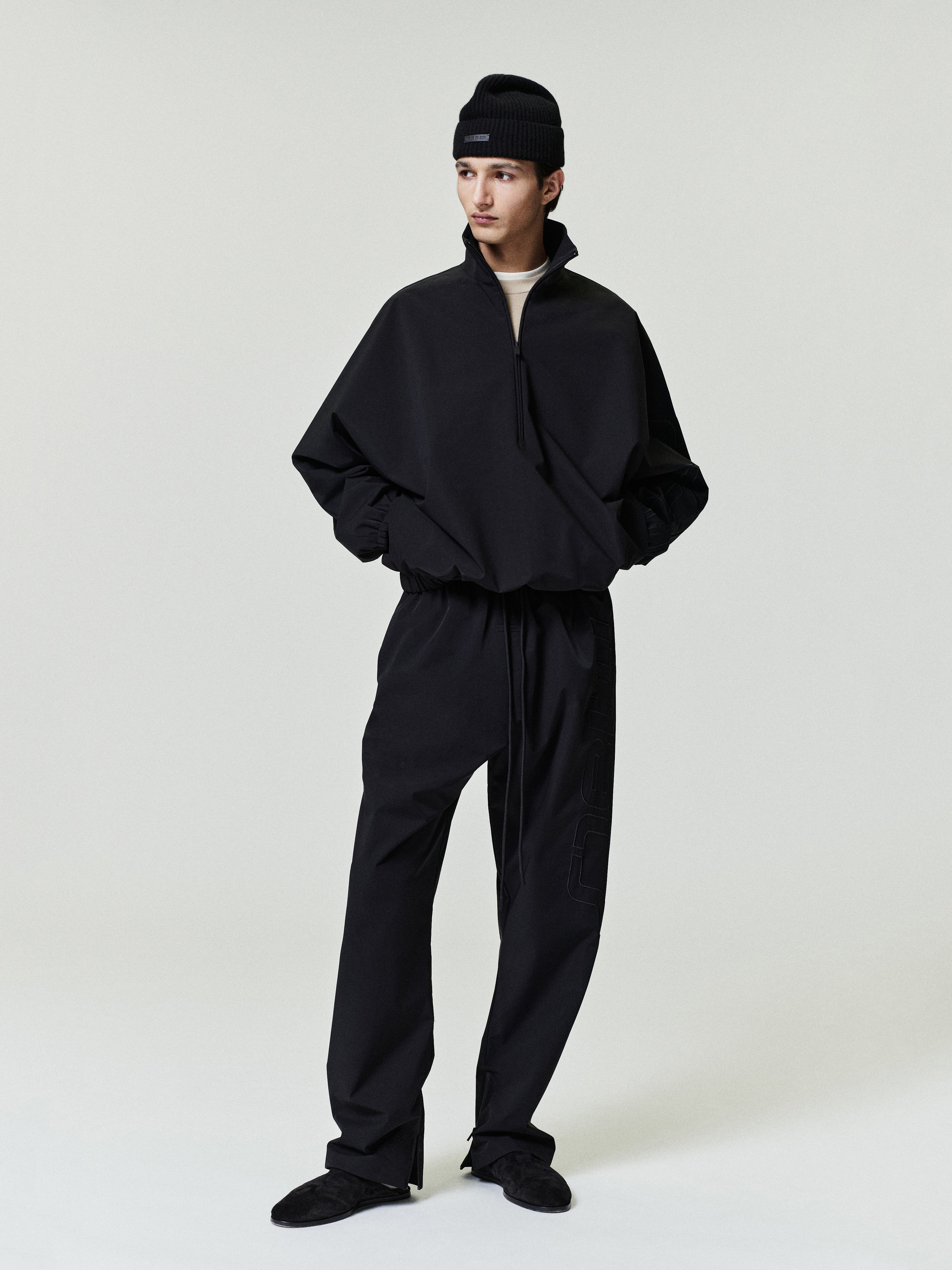 Person wearing a black outfit on a white background