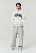 Front view of model wearing off-white Orlando Magic 90s Hoodie with black Orlando text and small NBA logo, image SP26_F_L64-P_3090