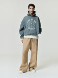 muted green oversized hoodie with puff-printed "FEAR OF GOD CELTICS" and basketball graphic on front worn by model