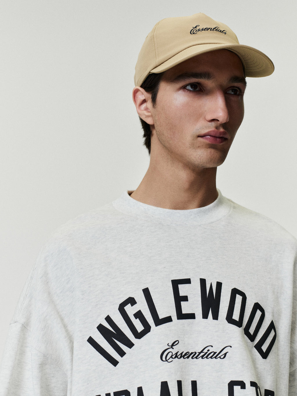 light grey oversized 90s-inspired heavy cotton tee with bold Inglewood text and Essentials script front chest design