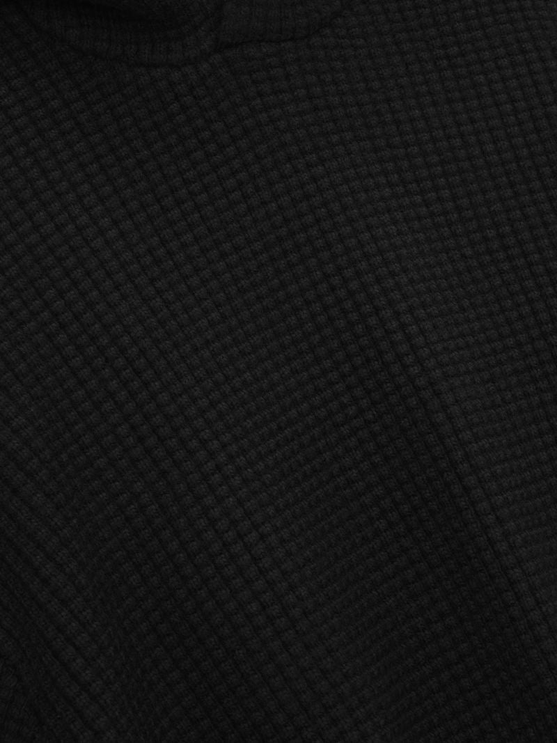 Detailed close-up of black Heavy Waffle 90s Hoodie fabric showcasing textured waffle knit pattern on first gallery image