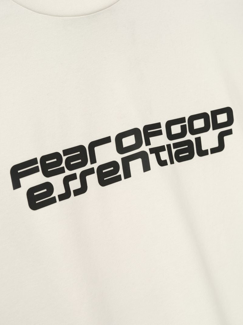 Close-up of off-white Ponte 90s Tee featuring black Fear of God Essentials logo angled across chest, file f46E3TfA.jpg gallery 0
