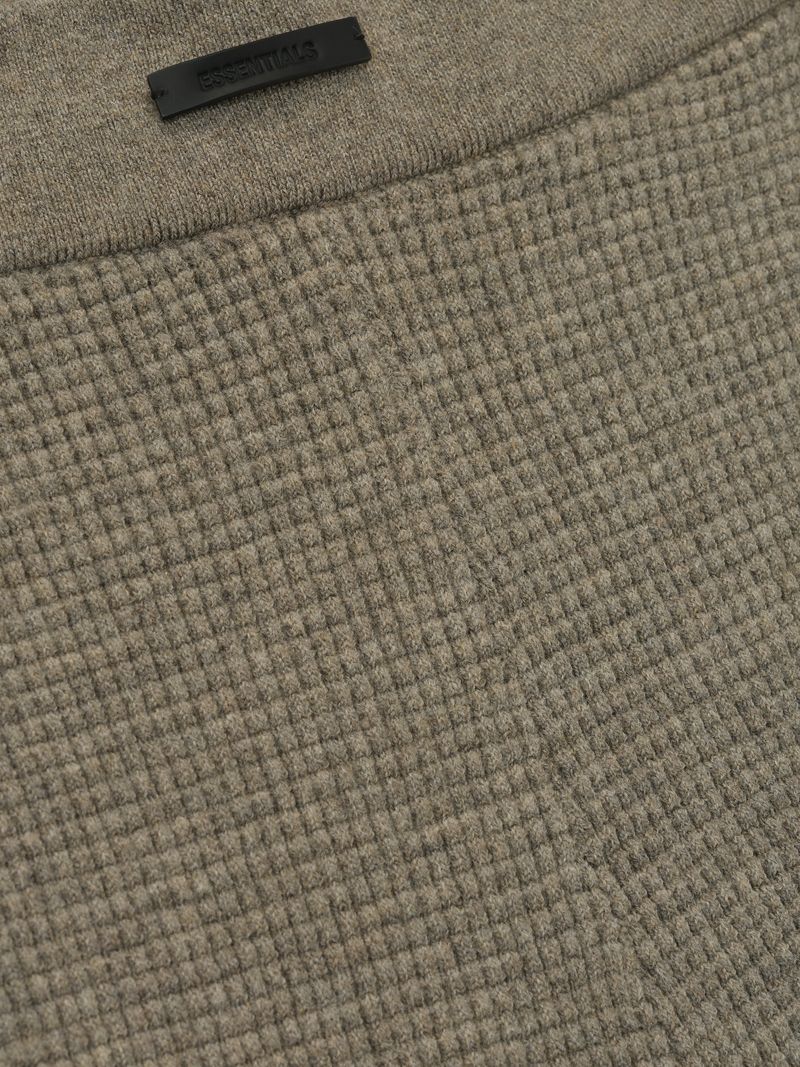 close-up of taupe poly-nylon waffle knit textured fabric and elastic waistband detail on women's biker shorts