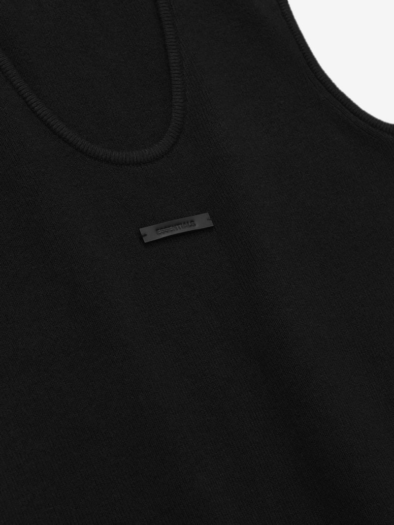 Close-up of black ribbed tank top with subtle black rectangular logo patch centered below neckline