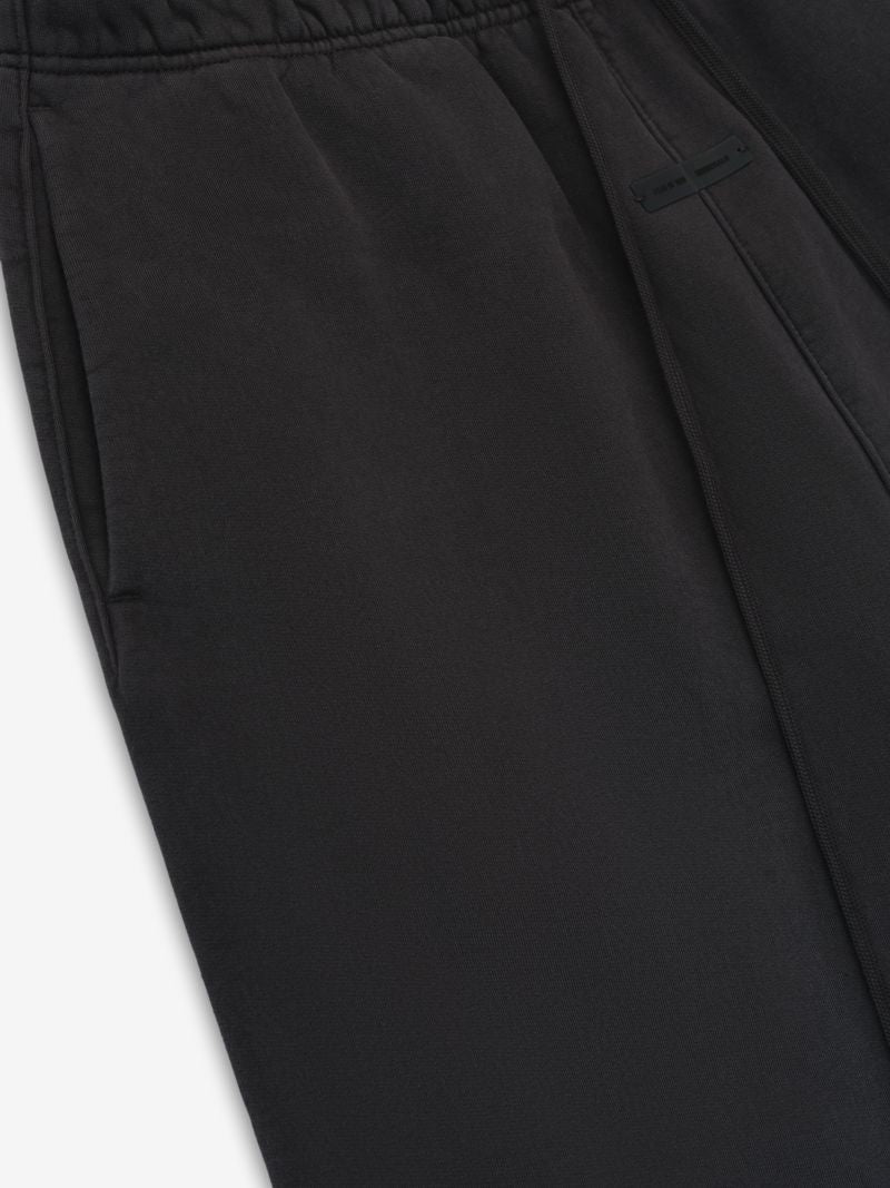Close-up of black Heavy Fleece Flare Sweatpant fabric and elastic waistband detail, gallery image 0, file wLaWwxg.jpg